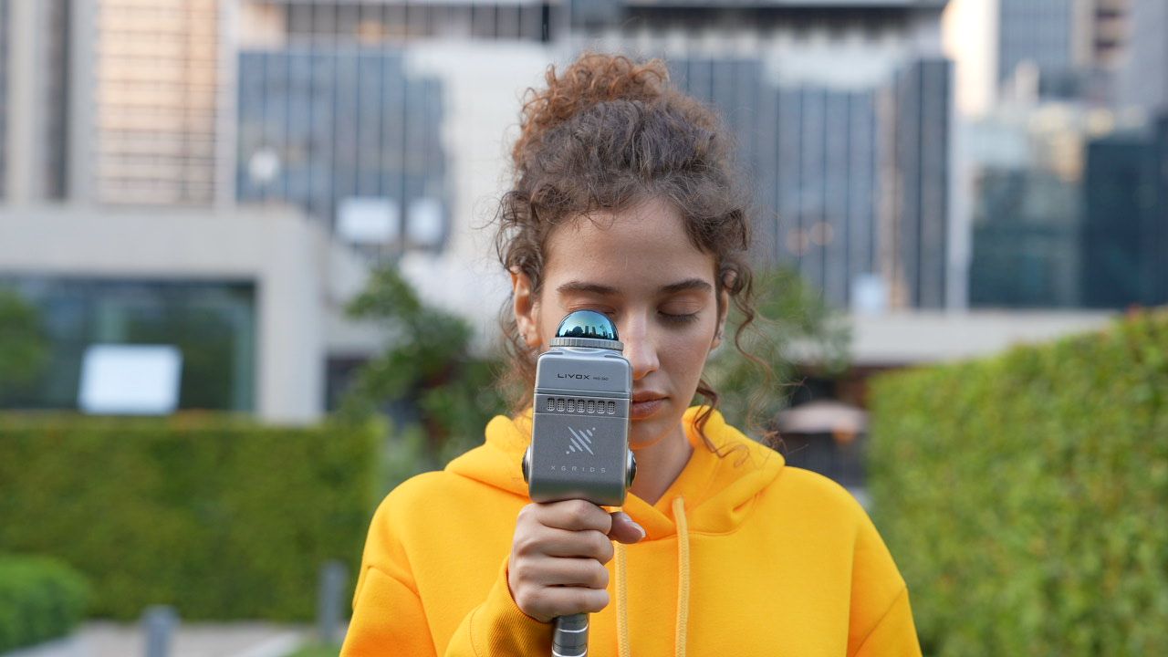 Close-up of the Lixel K1 handheld scanner in use