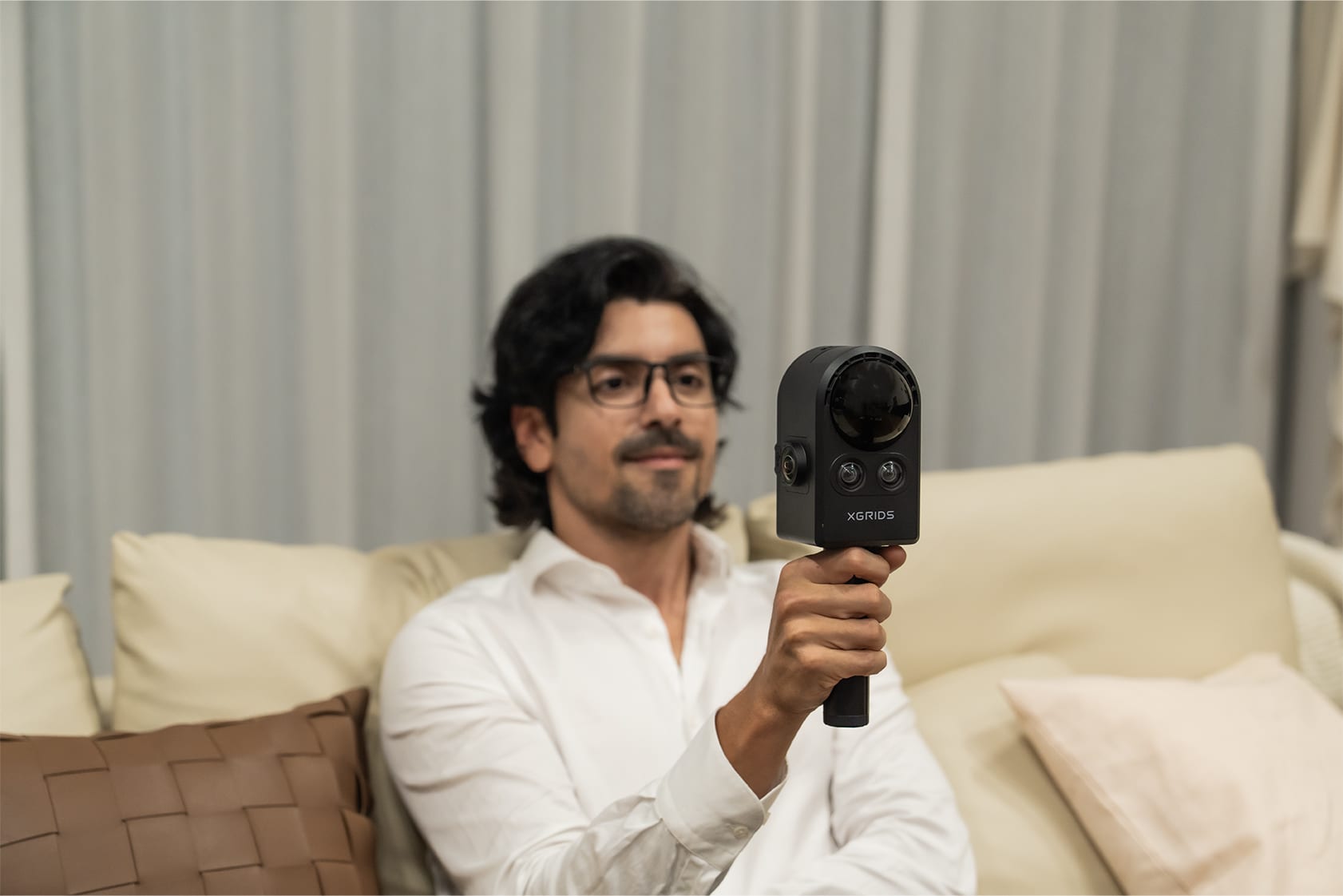PortalCam handheld scanner used indoors on a sofa